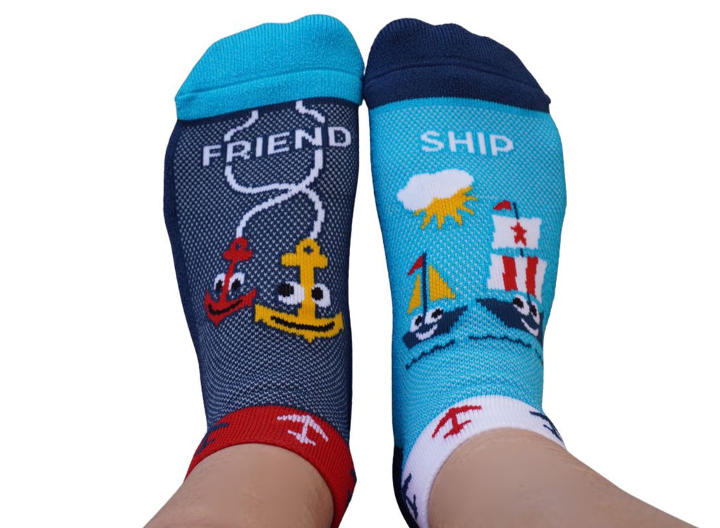 Two pairs of socks with pirate ship / anchor characters on a blue background
