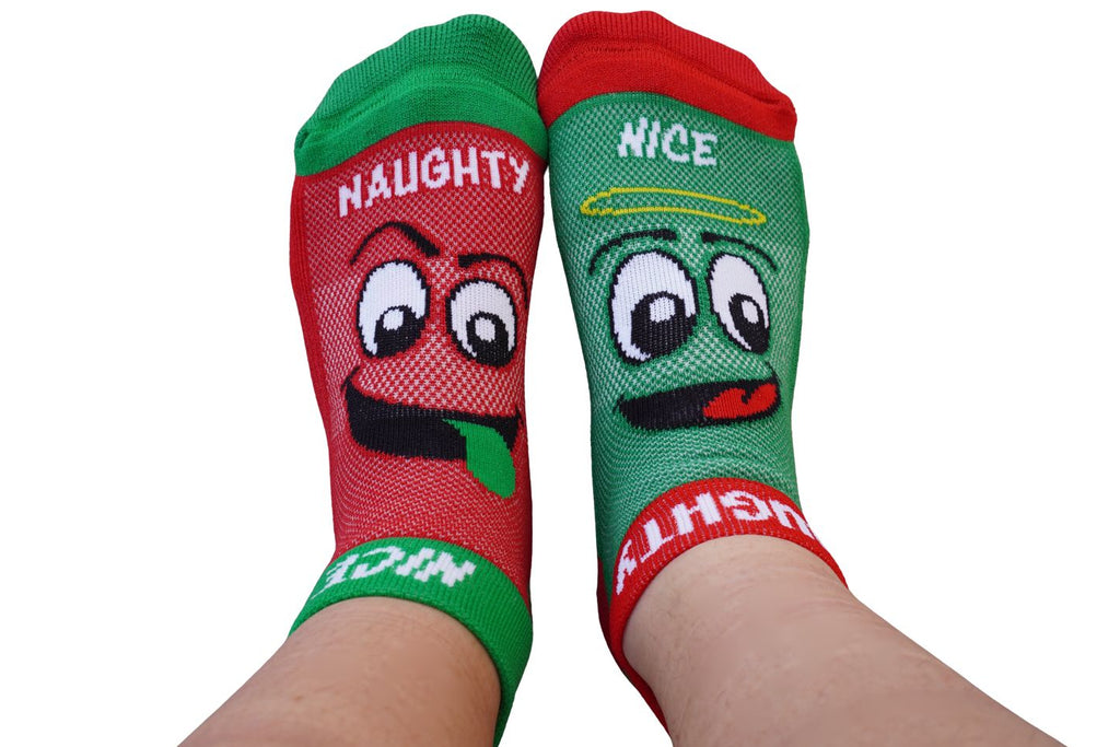 Two socks with cartoon faces labeled 'Naughty' and 'Nice' on a white background.

